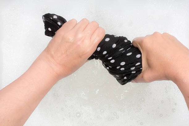 Hands gently washing delicate compression socks for women, preserving their quality and fit.