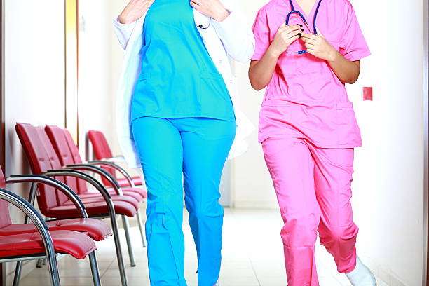 Healthcare professionals on duty; many wear compression socks for women for support.