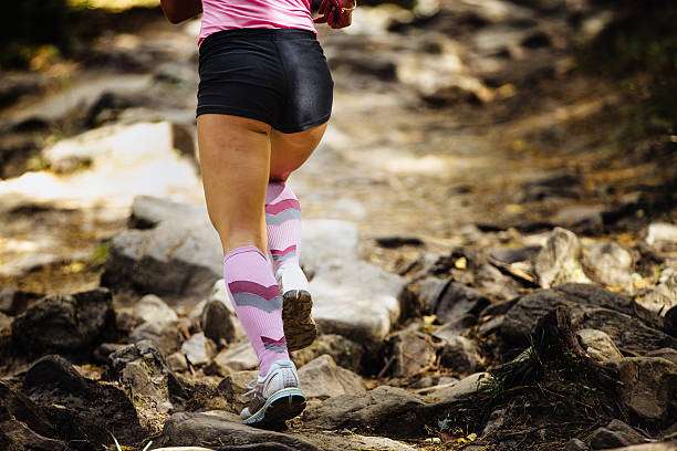 Runner's legs in pink and gray compression socks for women