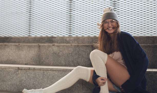 Happy woman wearing white thigh-high compression socks for women outdoors.